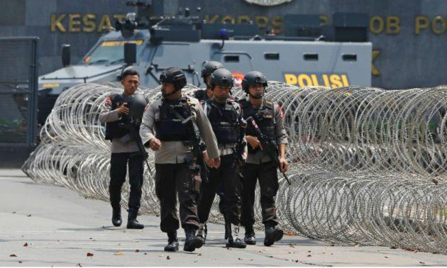 Five police, inmate dead in prison riot in Indonesia