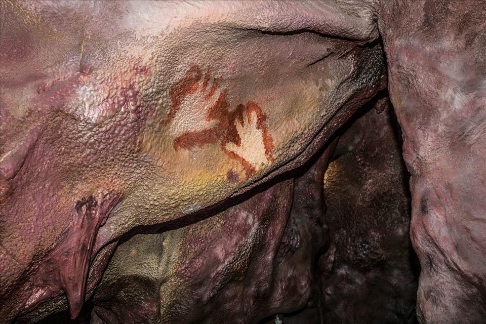 Were Neanderthals Capable Of Making Art? Neanderthal handprints in a replica of Maltravieso Cave, Spain.        WH Pics / Shutterstock